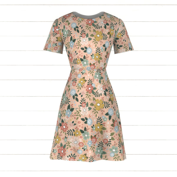 Kinley Blooms | multi colored flowers tossed on a light pink backgroun ...
