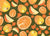 Handpainted gouache full oranges, orange slices, and orange wedges on an olive green color background. Image